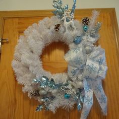 a white wreath with blue and silver decorations