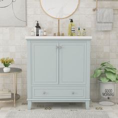 a bathroom with a sink, mirror and rug