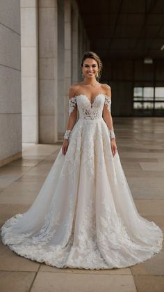 a woman in a wedding dress posing for the camera with her hands on her hips