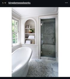 a bathroom with a bathtub and shelves in it