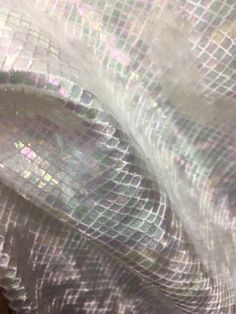 a close up view of the fabric with iridescent patterns on it, as seen from above