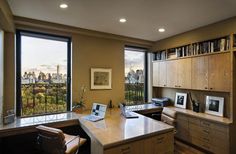 a home office with large windows overlooking the city