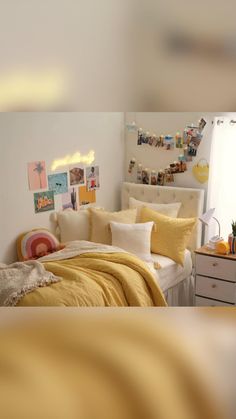 a bed room with a neatly made bed and pictures on the wall