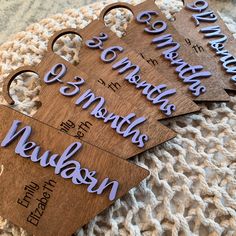 four wooden name tags with names on them