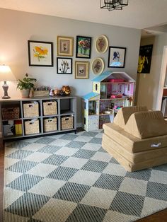 a living room filled with furniture and lots of pictures on the wall above it's shelves