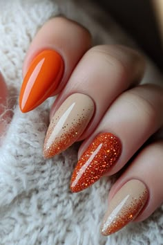 Get ready for fall with this gorgeous autumn-inspired nail design! Featuring a mix of solid orange, neutral beige, and glitter ombré accents, this manicure combines warm tones with a touch of sparkle, making it the perfect choice for seasonal vibes. Great for both casual wear and special occasions. Simple Fall Nails With Glitter, Fall Season Nails Orange, November Nail Designs Fall, Fall Almond Nails Ideas Orange, Almond Nails October 2024, Classy Oval Nails Fall, Burnt Orange Ombre Nails Fall, Orange Glitter Nails Fall, Thanksgiving Gel Nails Designs