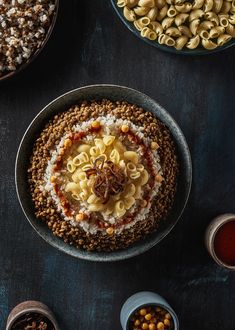 an overhead view of some food on a table with bowls and spoons next to it