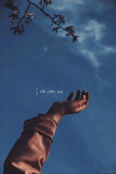 a hand reaching up into the sky with a quote above it that reads, i still want you