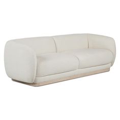 a white couch sitting on top of a wooden floor