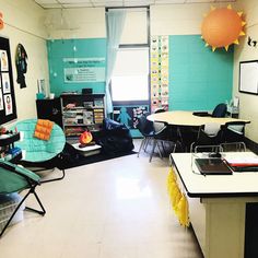 an empty classroom with desks, chairs and pictures on the wall in front of them