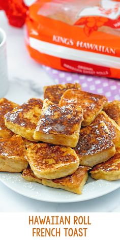 a white plate topped with french toast on top of a table