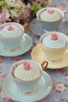 tea cups and saucers with pink roses on them