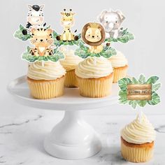 cupcakes on a cake stand with jungle animals topper and name tags in the middle