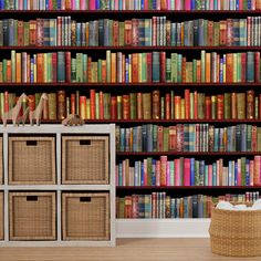 a bookshelf filled with lots of colorful books next to a wicker basket