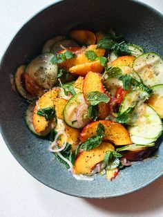 a bowl filled with lots of vegetables on top of a table