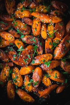 roasted carrots with sesame seeds and parsley in a skillet, ready to be eaten