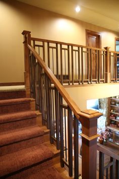 the stairs are made of wood and have brown carpet