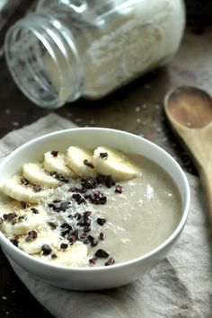 a bowl of oatmeal with banana slices and chocolate chips on the side