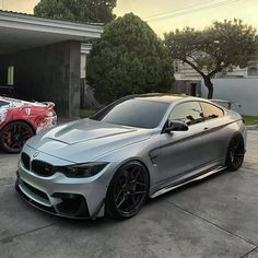 two cars parked next to each other in front of a house