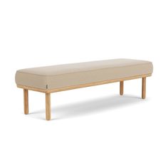 a bench made out of wood and fabric with a beige seat cushion on the back