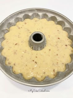 a cake pan filled with batter on top of a white table