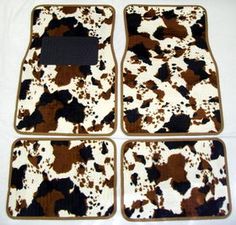 four brown and white animal print floor mats