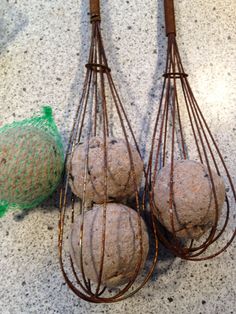 three metal wire baskets filled with balls on top of a counter next to a green bag