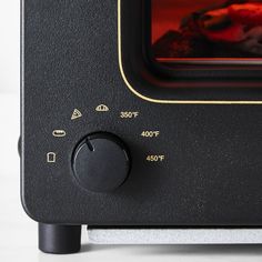 a close up view of an oven with the door open and red flame coming out