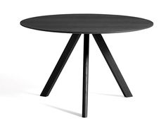 a round table with two black legs and a white back ground, in front of a white background