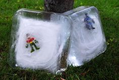 an ice block with flowers and two small figurines in it