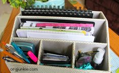 an organized desk organizer with pens, pencils and other office supplies in it on a wooden table