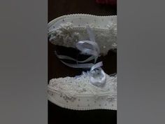 a pair of white shoes with lace and bows on the bottom are shown in this undrecognizable image