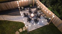 an overhead view of a patio with lights on the ground and chairs in the middle