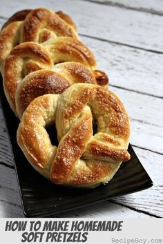 homemade soft pretzels sitting on a black plate