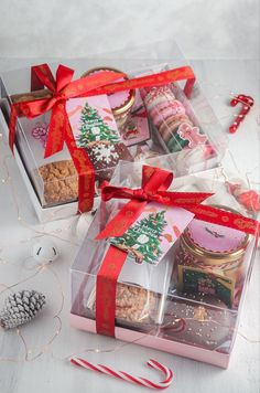 a box filled with lots of different types of cookies and candies next to a candy cane