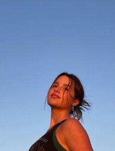 a woman standing in front of a blue sky