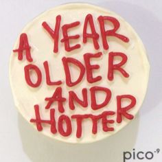 a white cake with red icing that says a year older and hotter on it