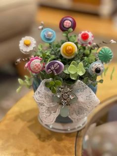 a vase filled with lots of different colored flowers