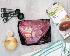 raw meat and ingredients laid out on a table