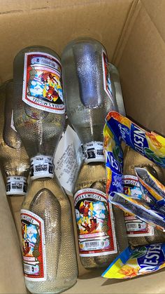 a cardboard box filled with water bottles and toothbrushes on top of each other