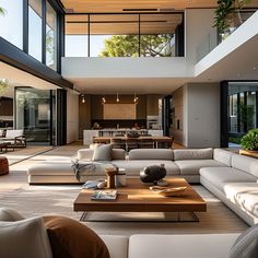 a living room filled with lots of furniture and large glass windows on top of it