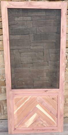 a wooden frame with a window on top of it and brick wall in the background