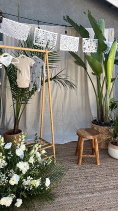 there are many potted plants on the outside of this house with clothes hanging up to dry