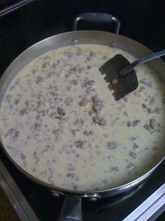 a pan filled with food sitting on top of a stove next to a burner