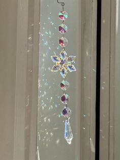 a glass window with a snowflake hanging from it's side in front of a door