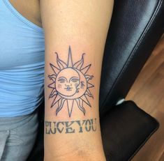 a woman's arm with a sun and the words luck you tattooed on it