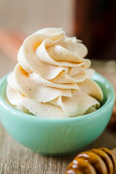 a blue bowl filled with whipped cream and honey