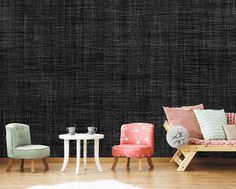 a living room filled with furniture next to a wall covered in black and pink fabric