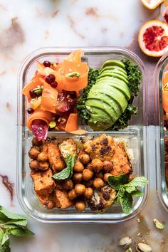 two plastic containers filled with food sitting on top of a marble counter next to fruit and vegetables