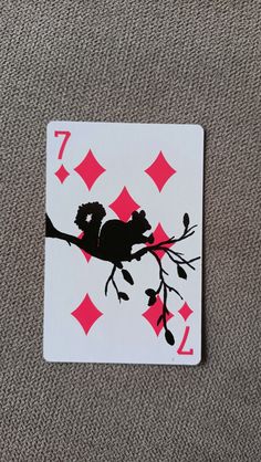 a playing card with an image of a koala sitting on top of a tree branch